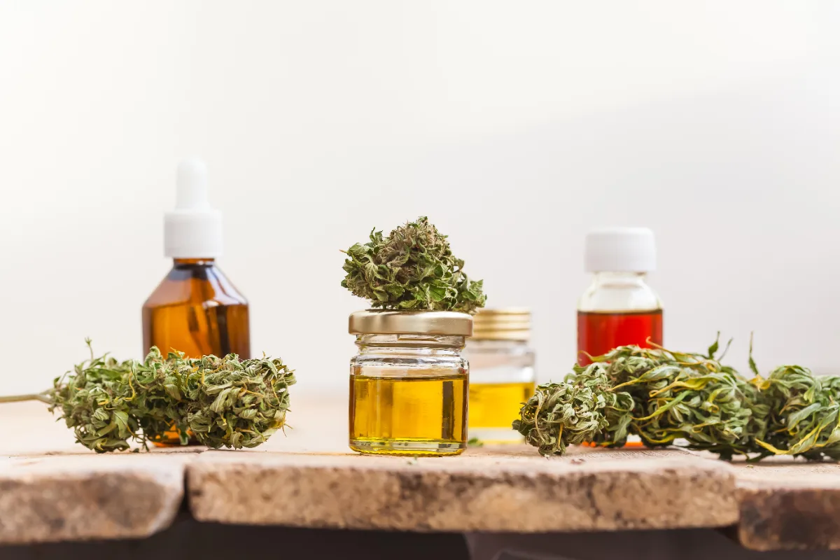 Bottles of oil, jars, and dried cannabis buds